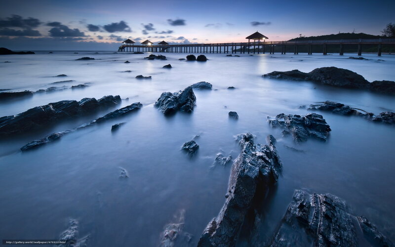 Pier at dusk with rocks