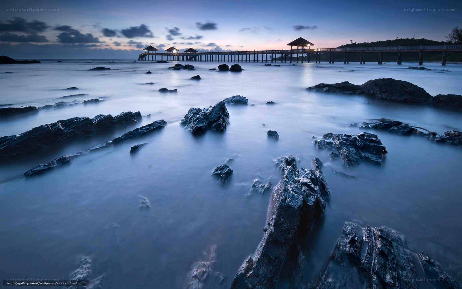 Pier at dusk with rocks