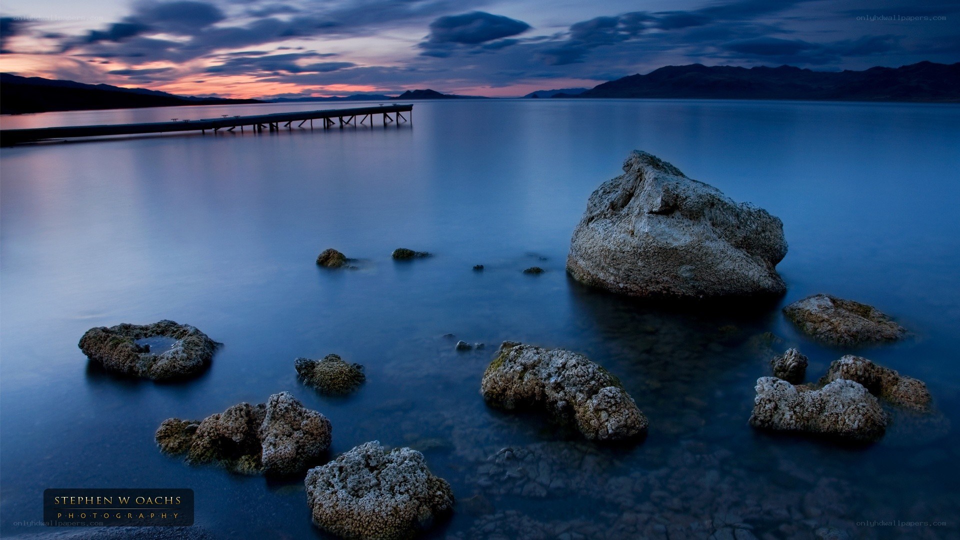 Pier at dusk with rocks