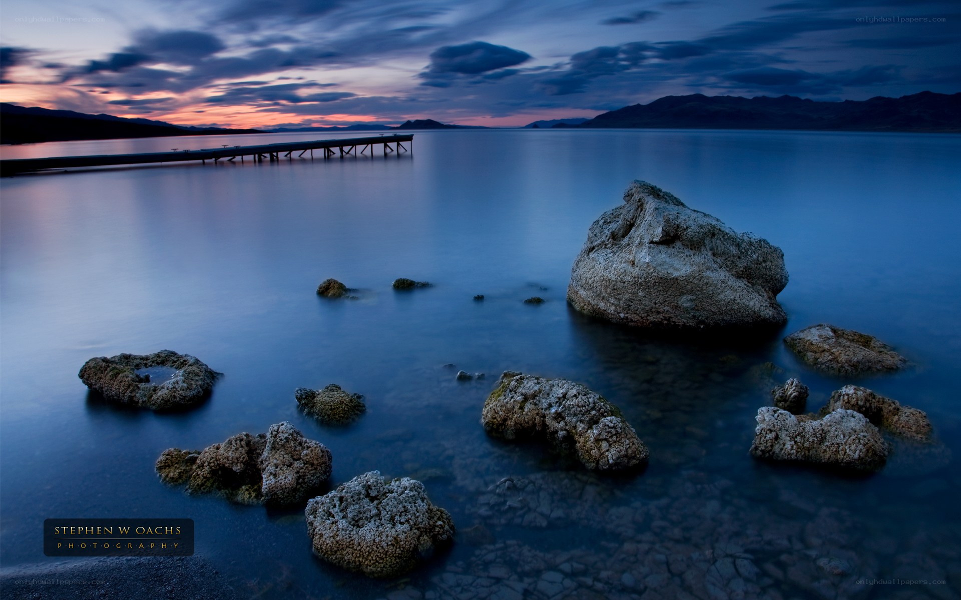 Pier at dusk with rocks