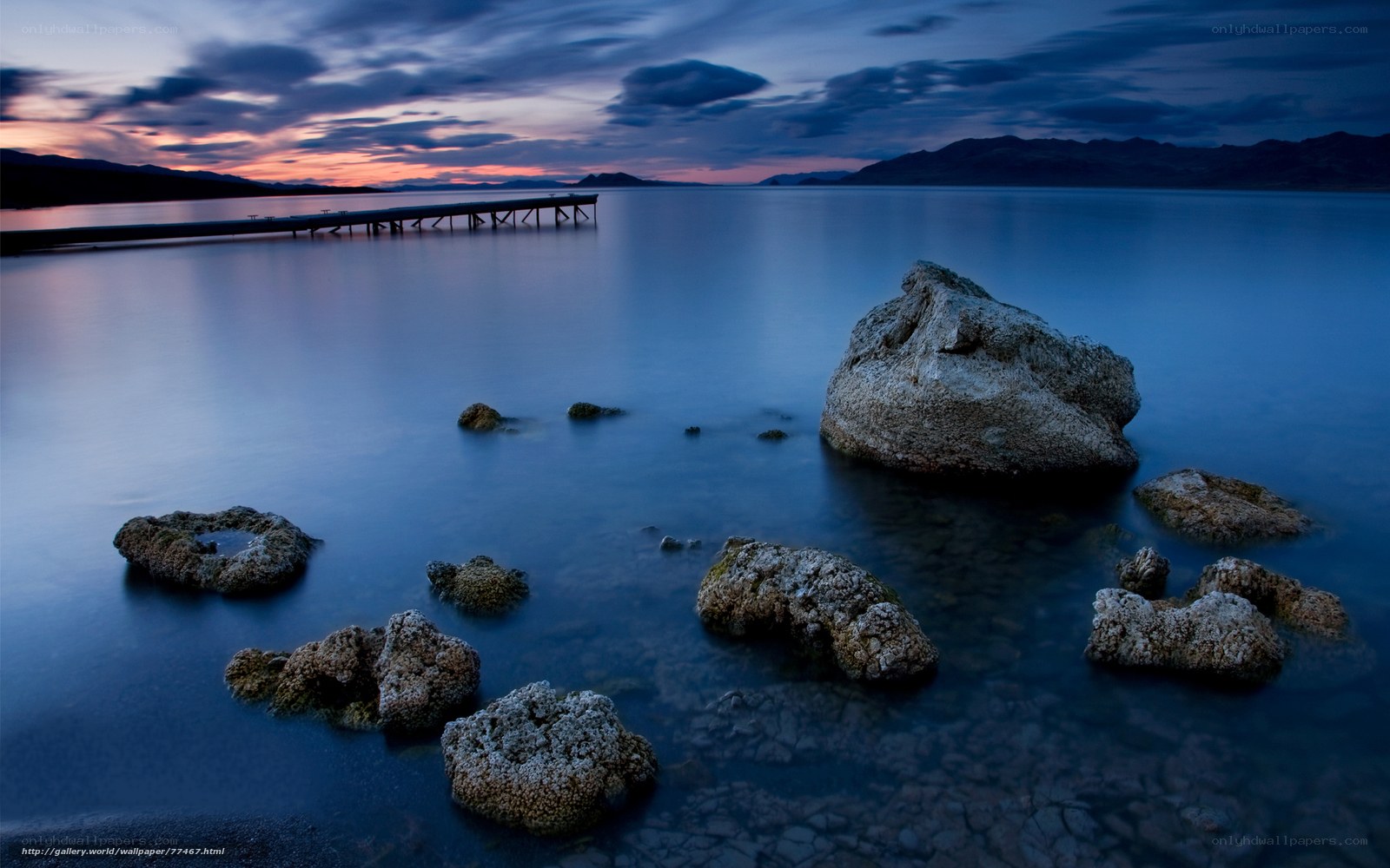 Pier at dusk with rocks
