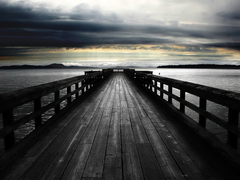 Pier at dusk with stormy sky