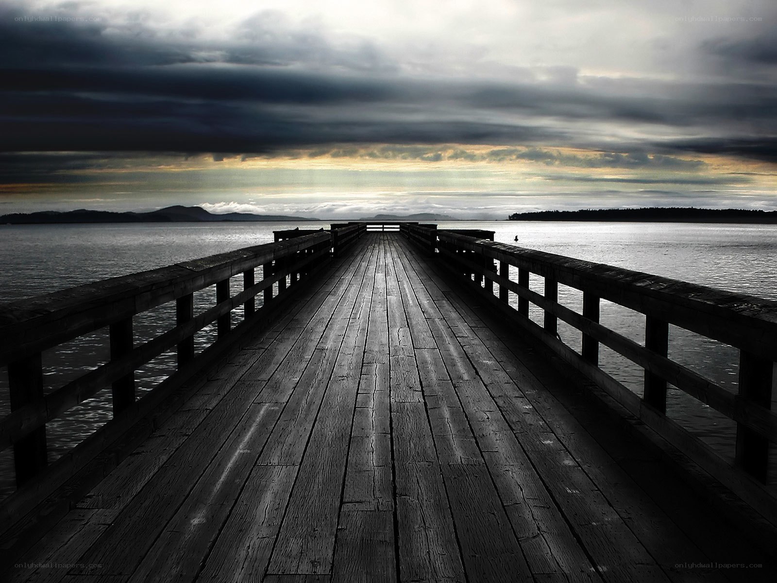 Pier at dusk with stormy sky