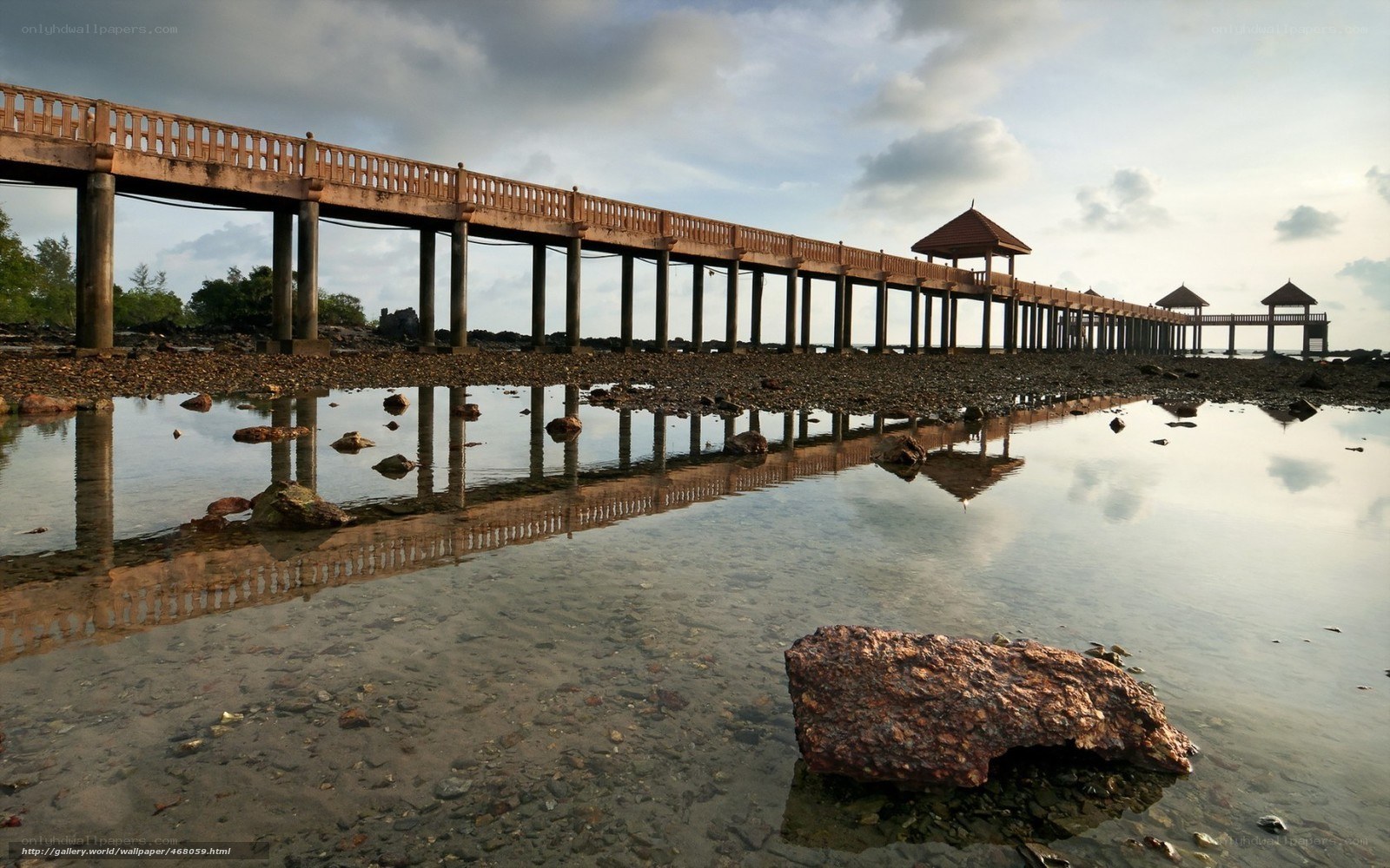 Pier at low tide with reflection