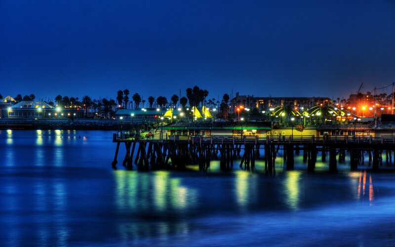 Pier at Night — Blue, Calm, Photograph, Buildings, Palm Trees