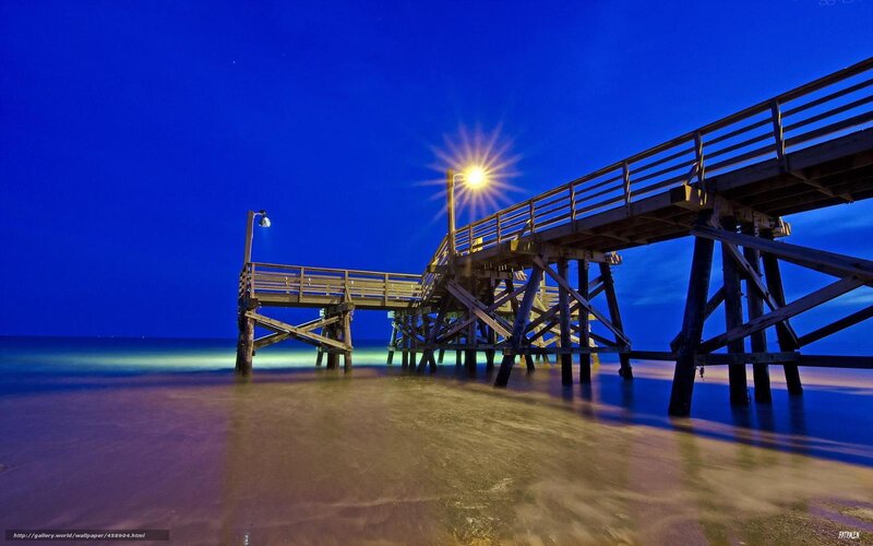 Pier at night with starburst light