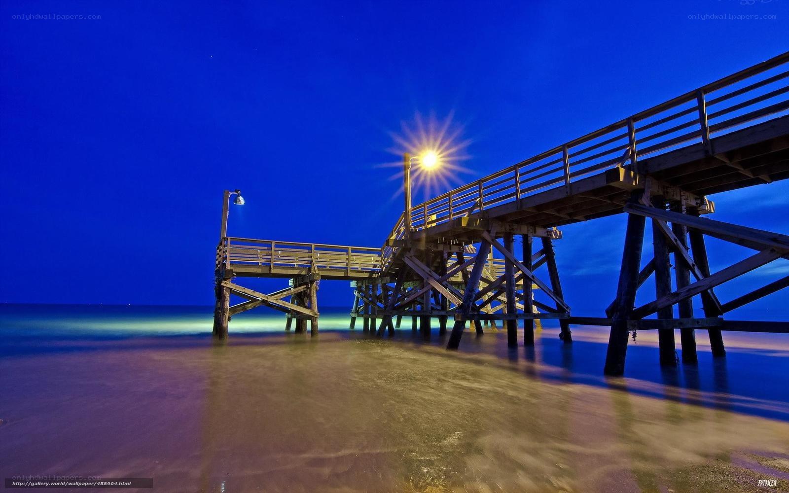 Pier at night with starburst light