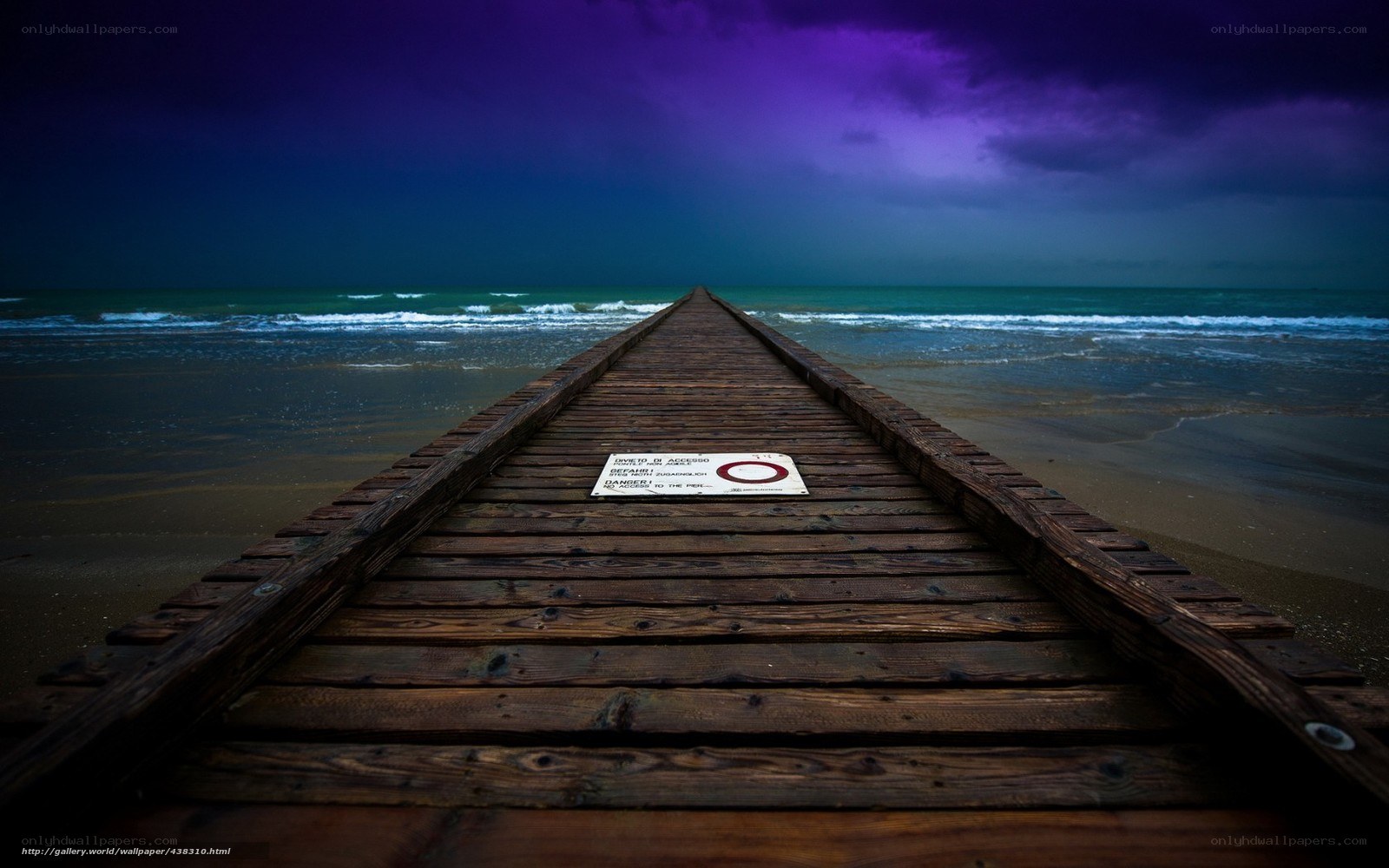 Pier at stormy beach