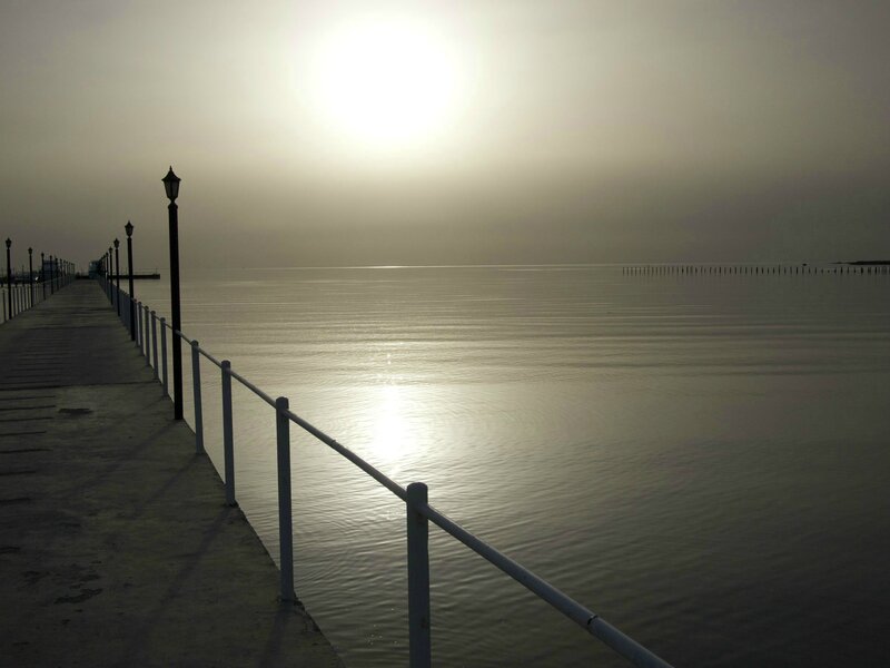 Pier at sunrise over calm water