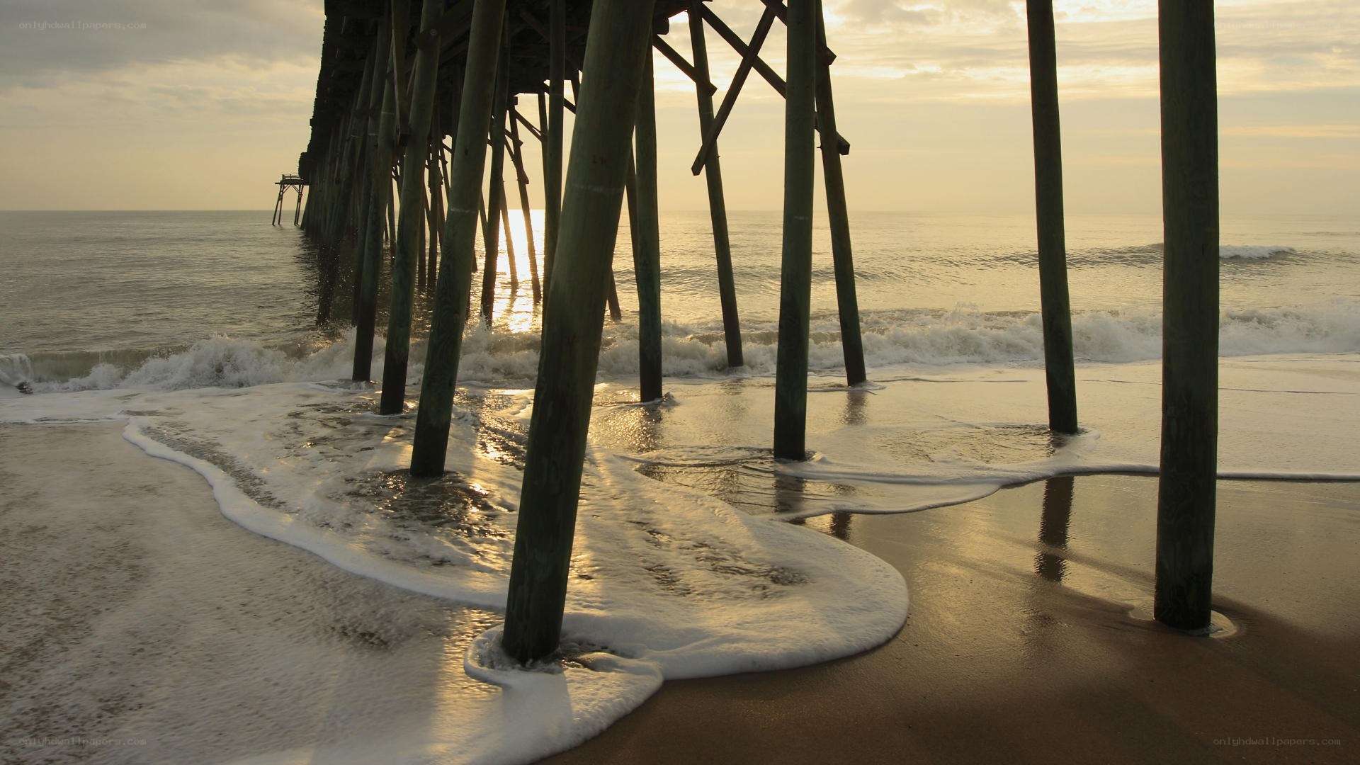 Pier at sunrise with waves