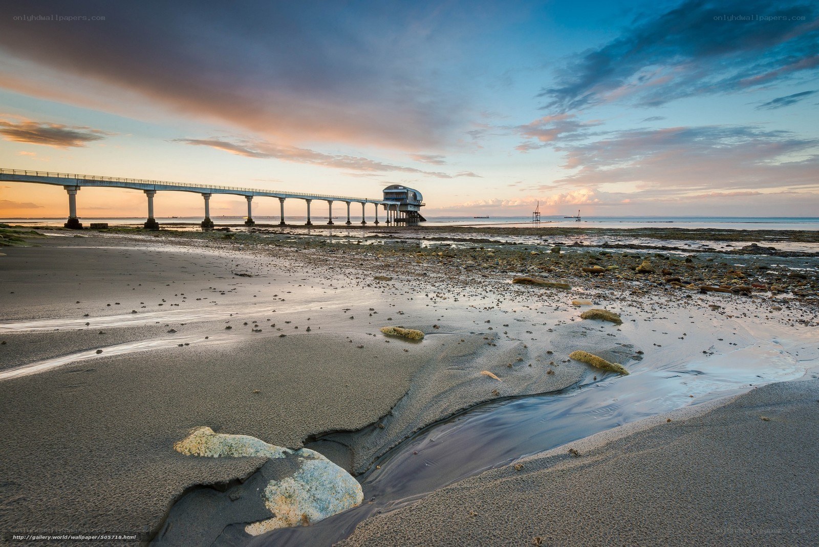 Pier at sunset on a beach