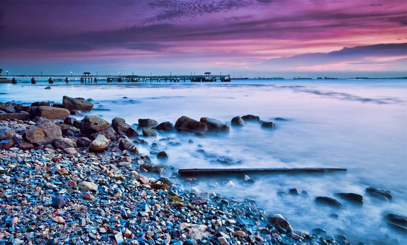 Pier at sunset on a rocky shore