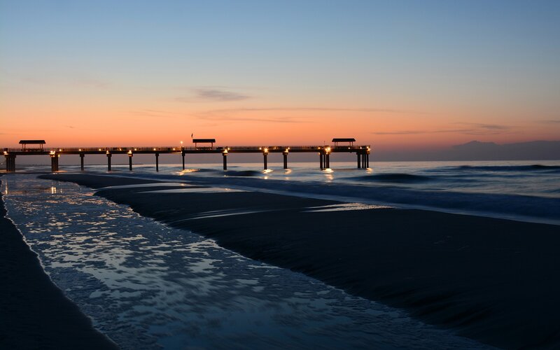 Pier at sunset on the beach