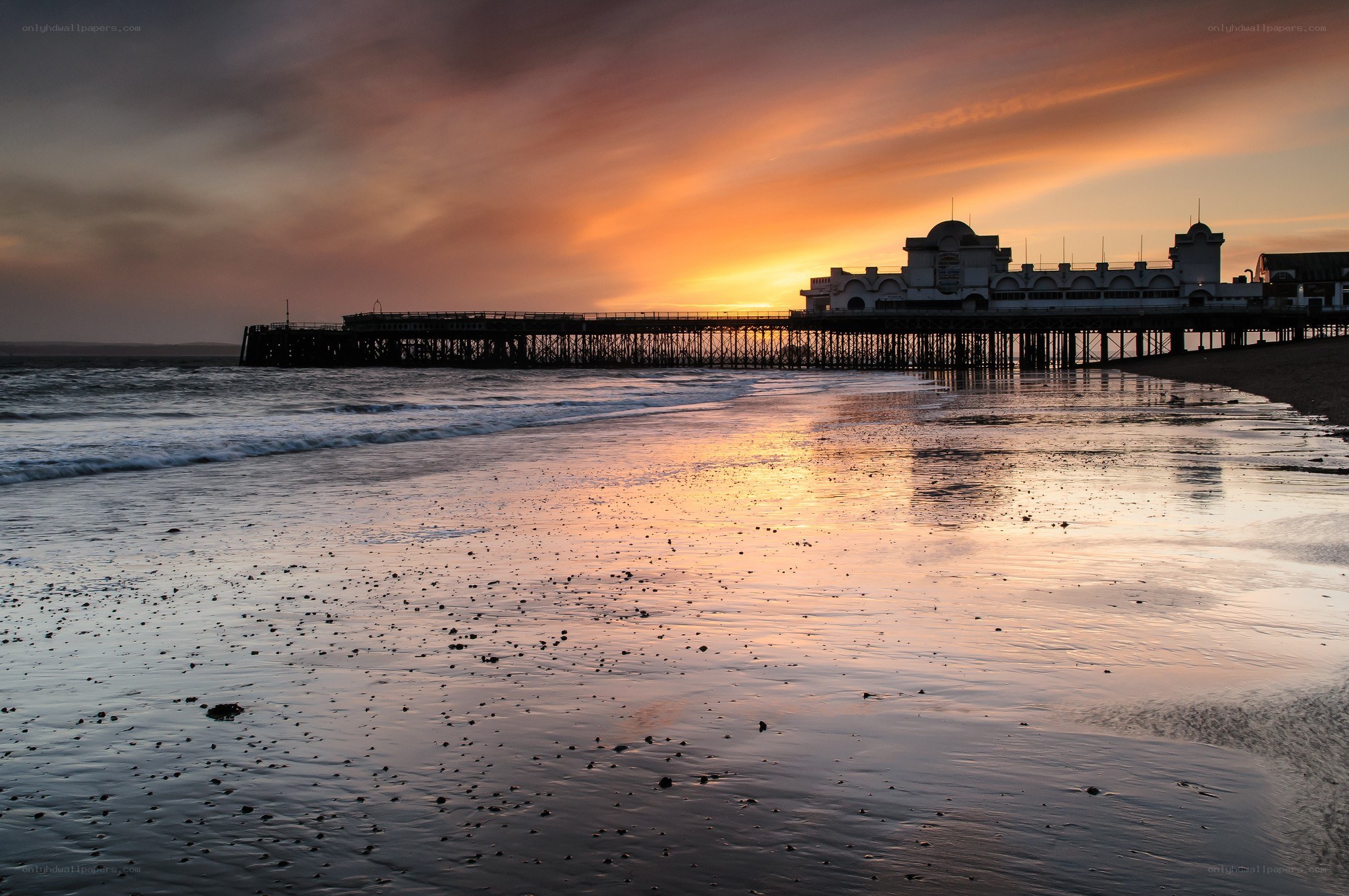 Pier at sunset on the beach