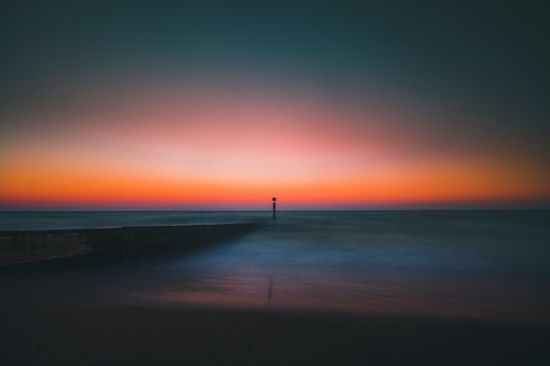 Pier at Sunset — Orange, Serene, Photograph, Ocean, Sky, Pole