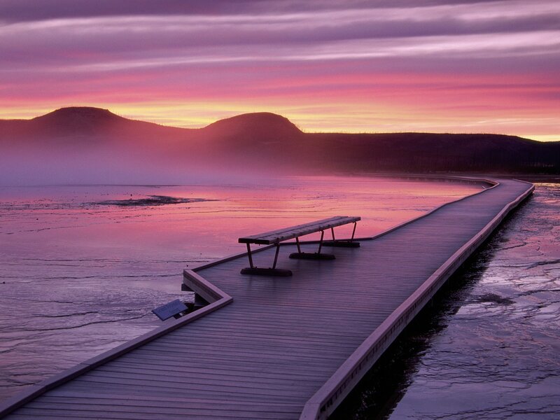 Pier at sunset over a frozen lake