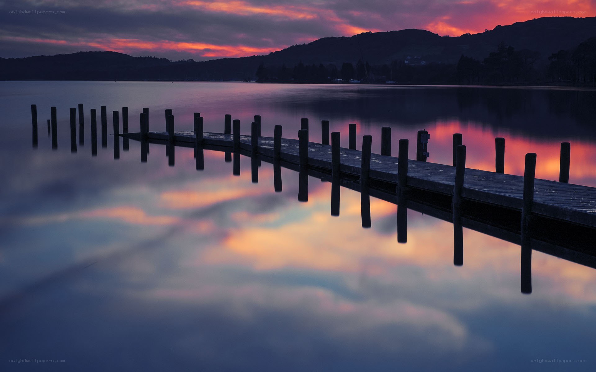Pier at sunset over a lake
