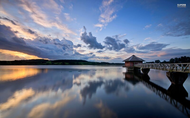 Pier at sunset over calm lake