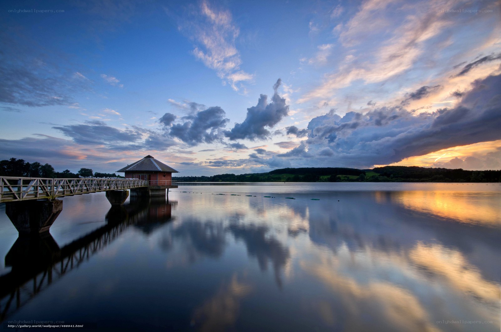 Pier at sunset over calm lake