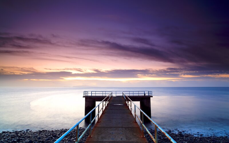 Pier at sunset over calm sea