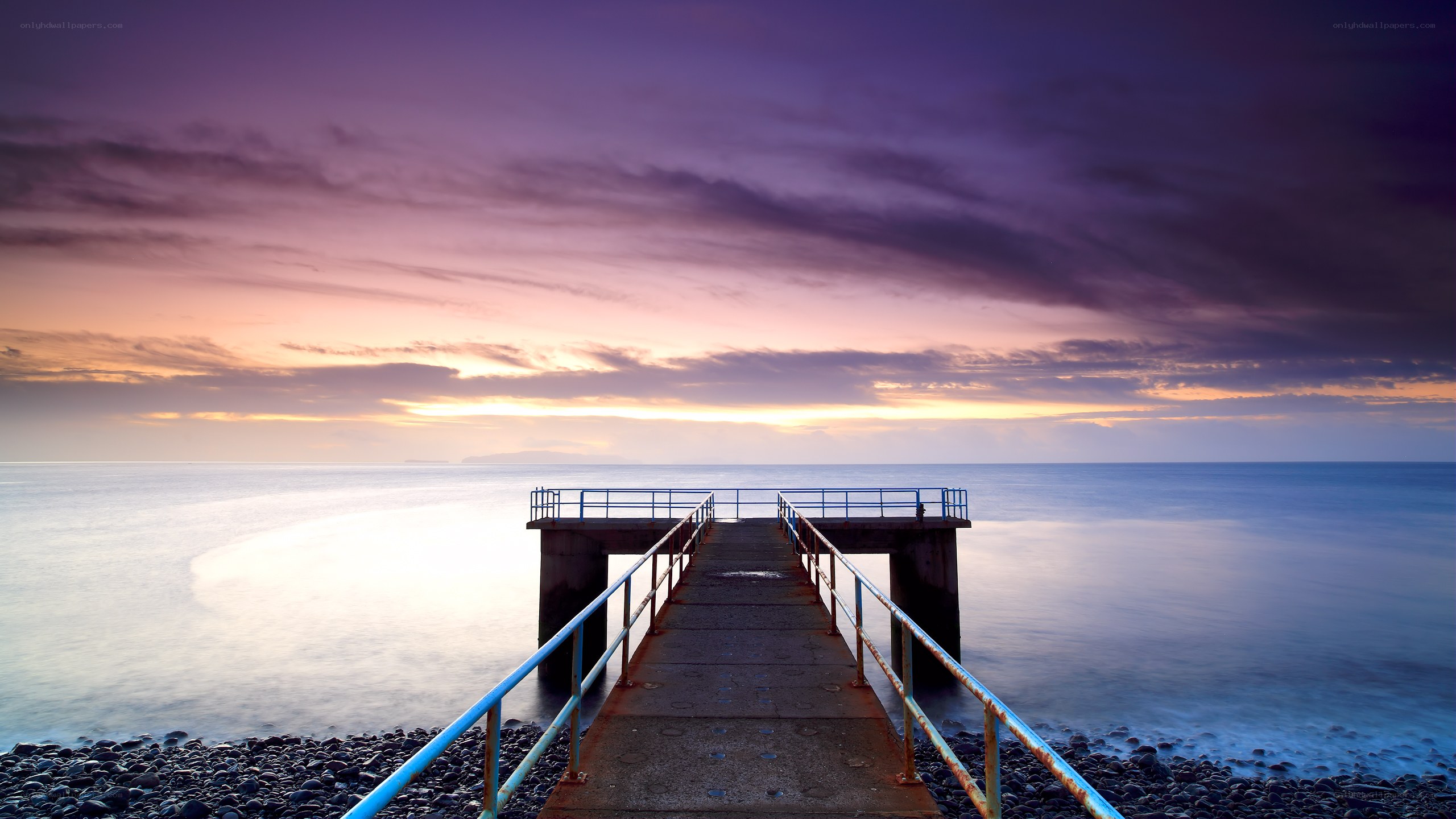 Pier at sunset over calm sea