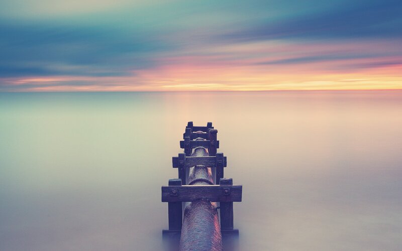 Pier at sunset over calm sea
