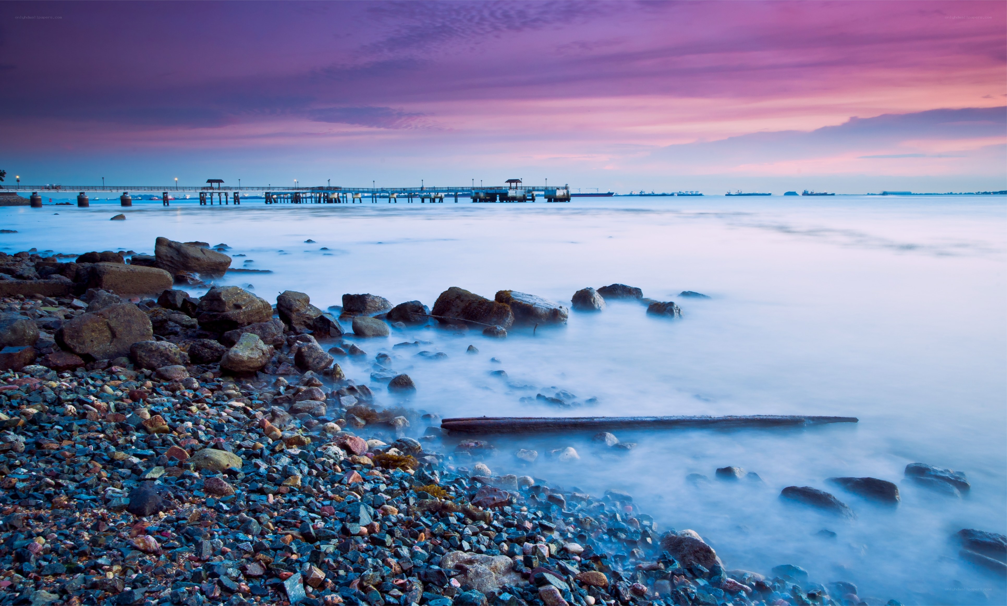 Pier at sunset over calm sea