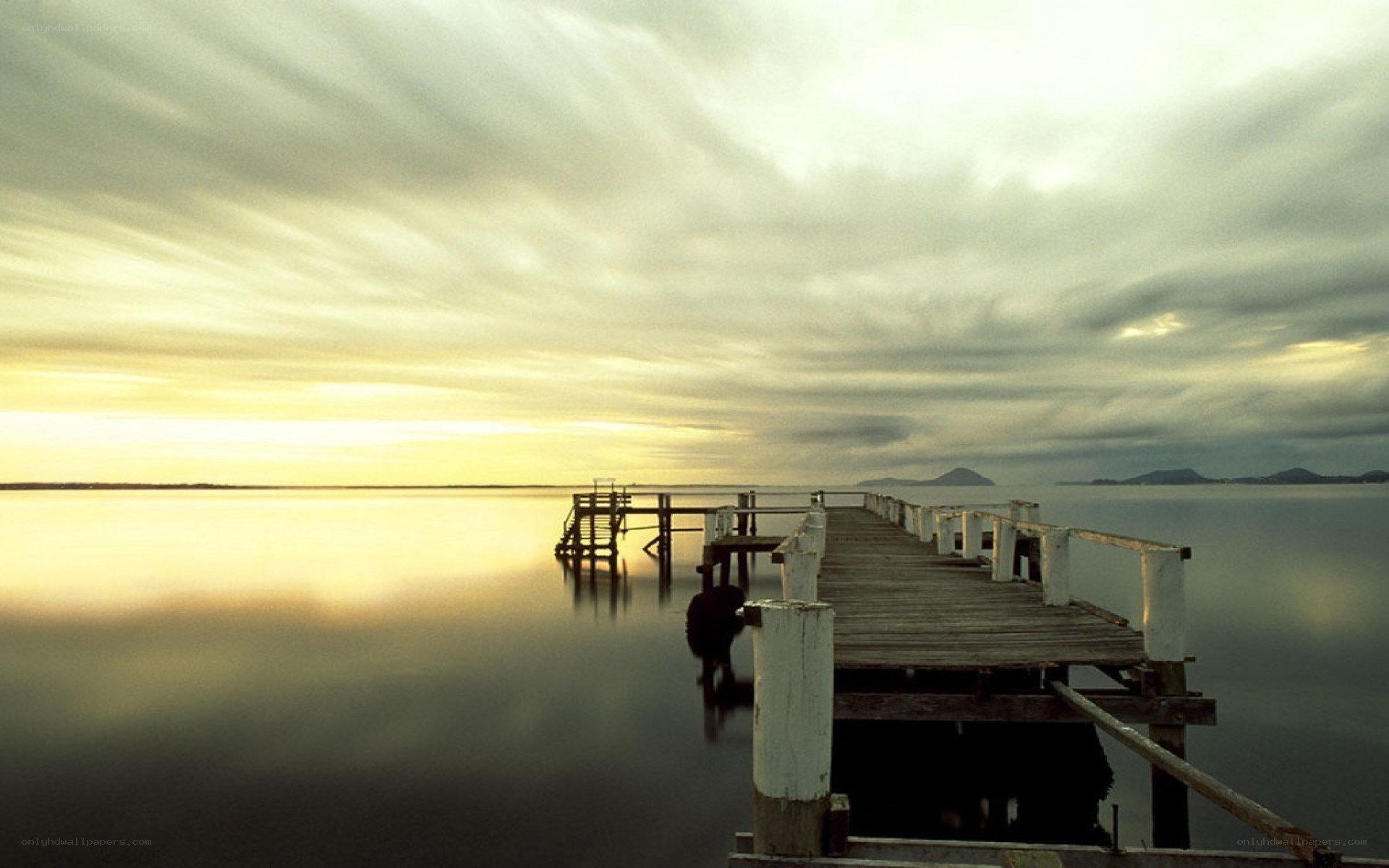 Pier at sunset over calm water