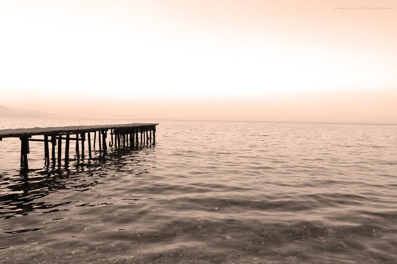 Pier at sunset over calm water