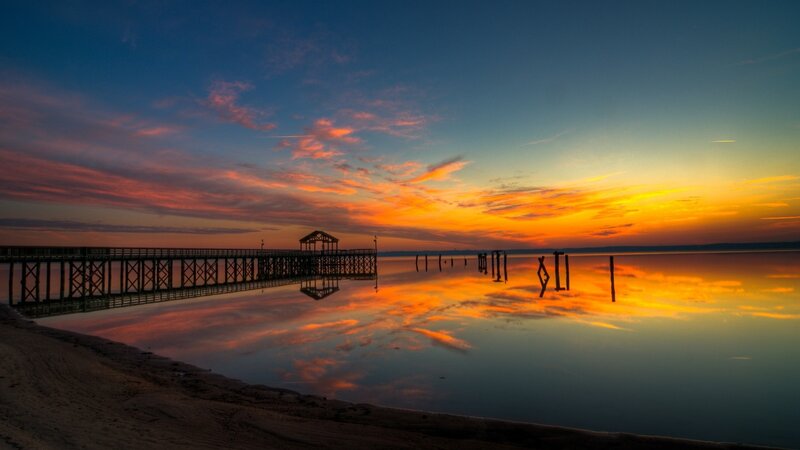 Pier at sunset over calm water