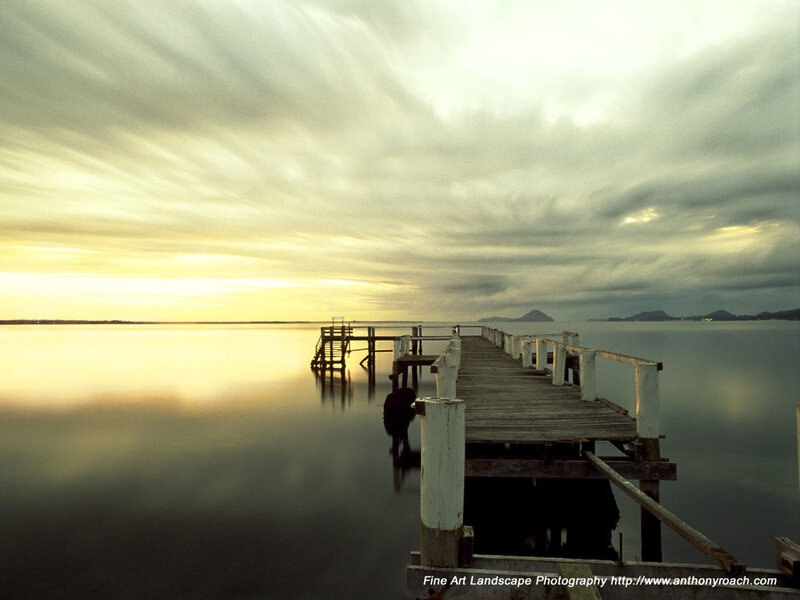 Pier at sunset over calm water