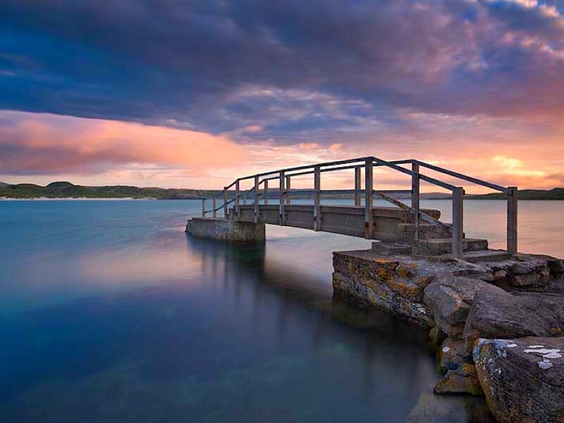 Pier at sunset over calm water