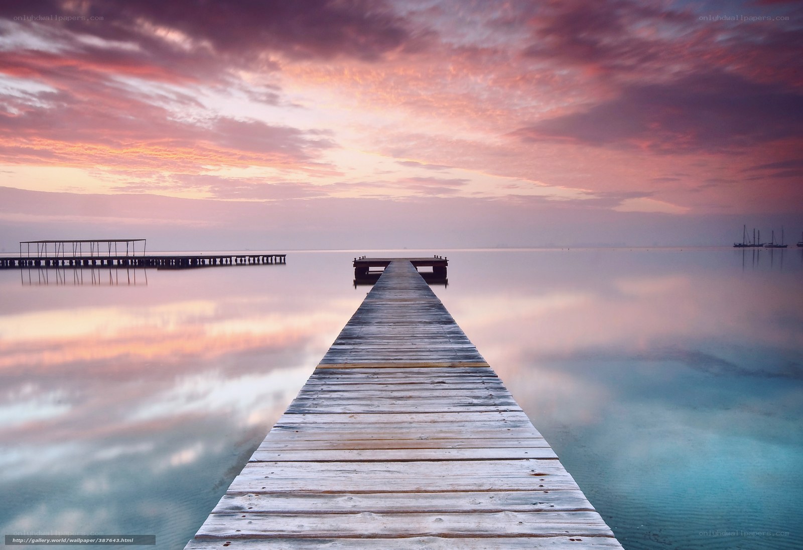 Pier at sunset over calm water