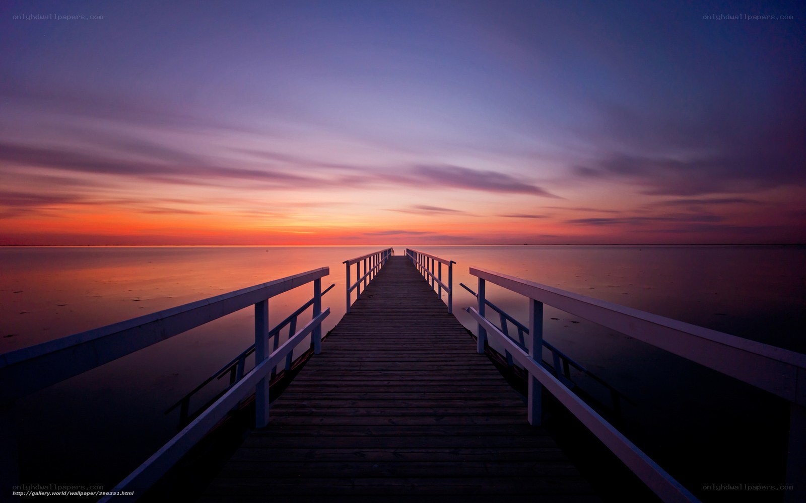 Pier at sunset over calm water