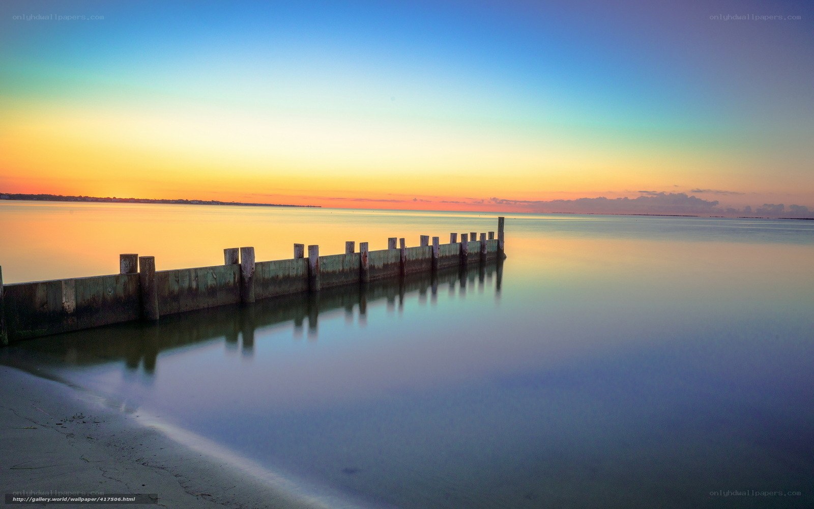 Pier at sunset over calm water