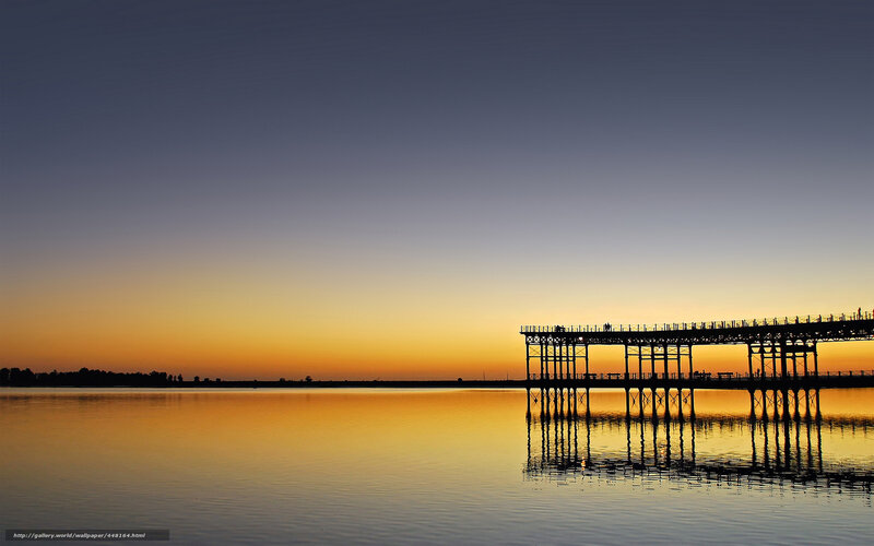 Pier at sunset over calm water