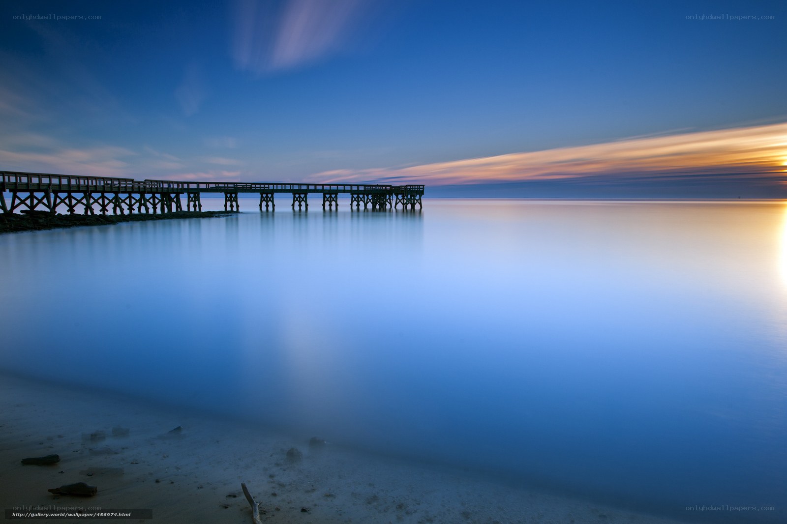 Pier at sunset over calm water