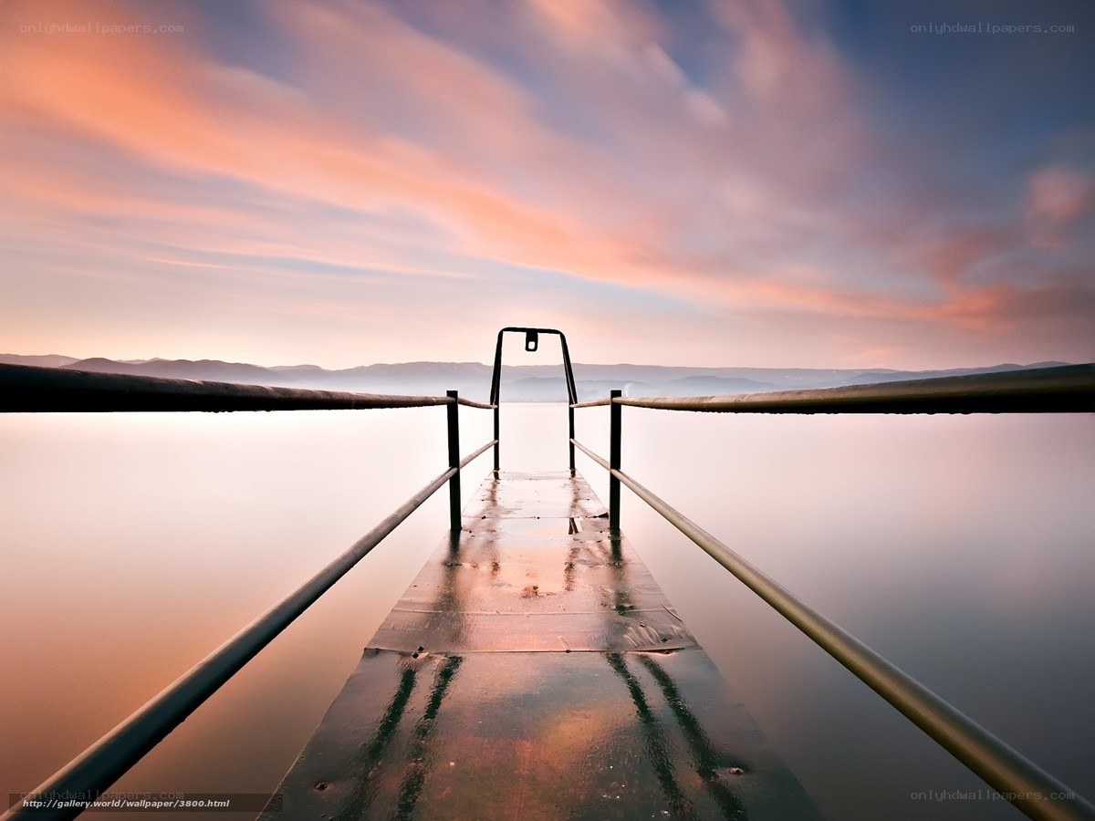 Pier at sunset over calm water