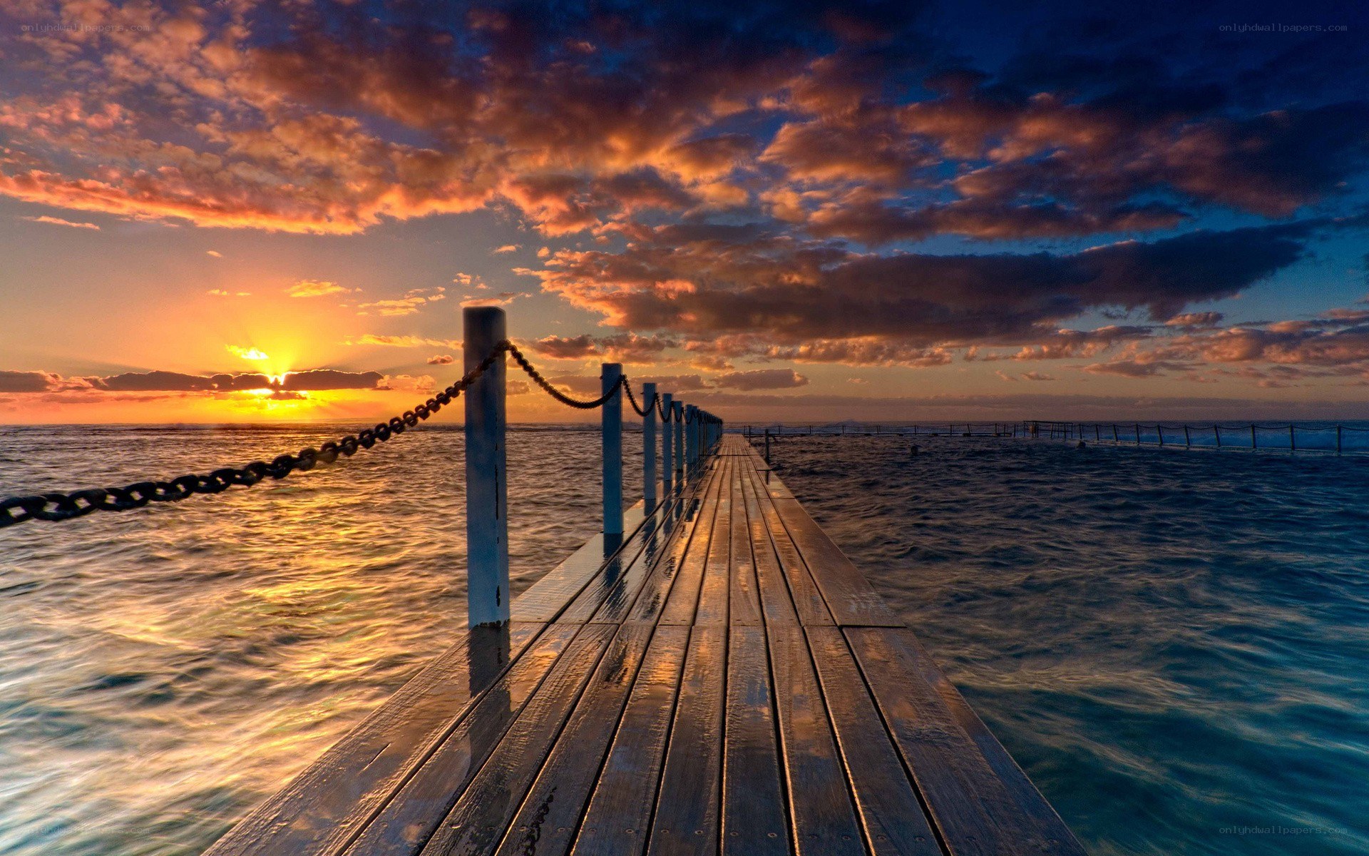 Pier at sunset over ocean