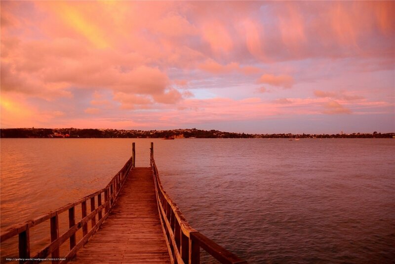 Pier at sunset over water
