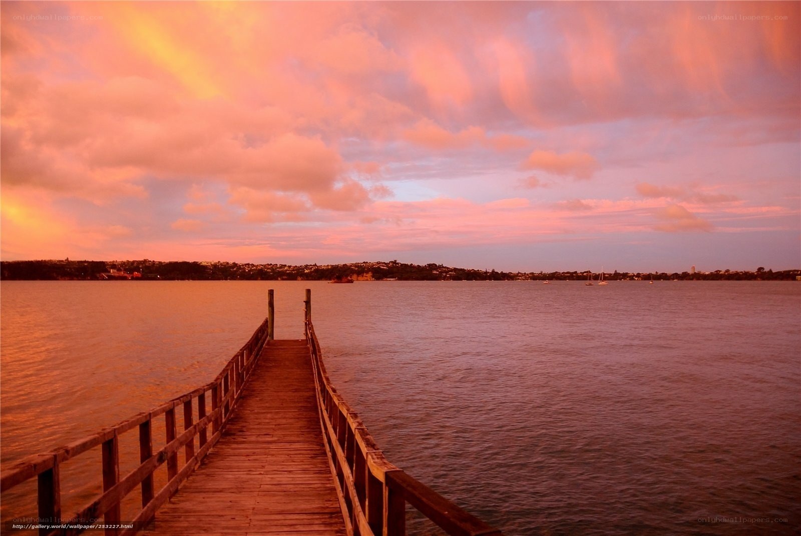 Pier at sunset over water