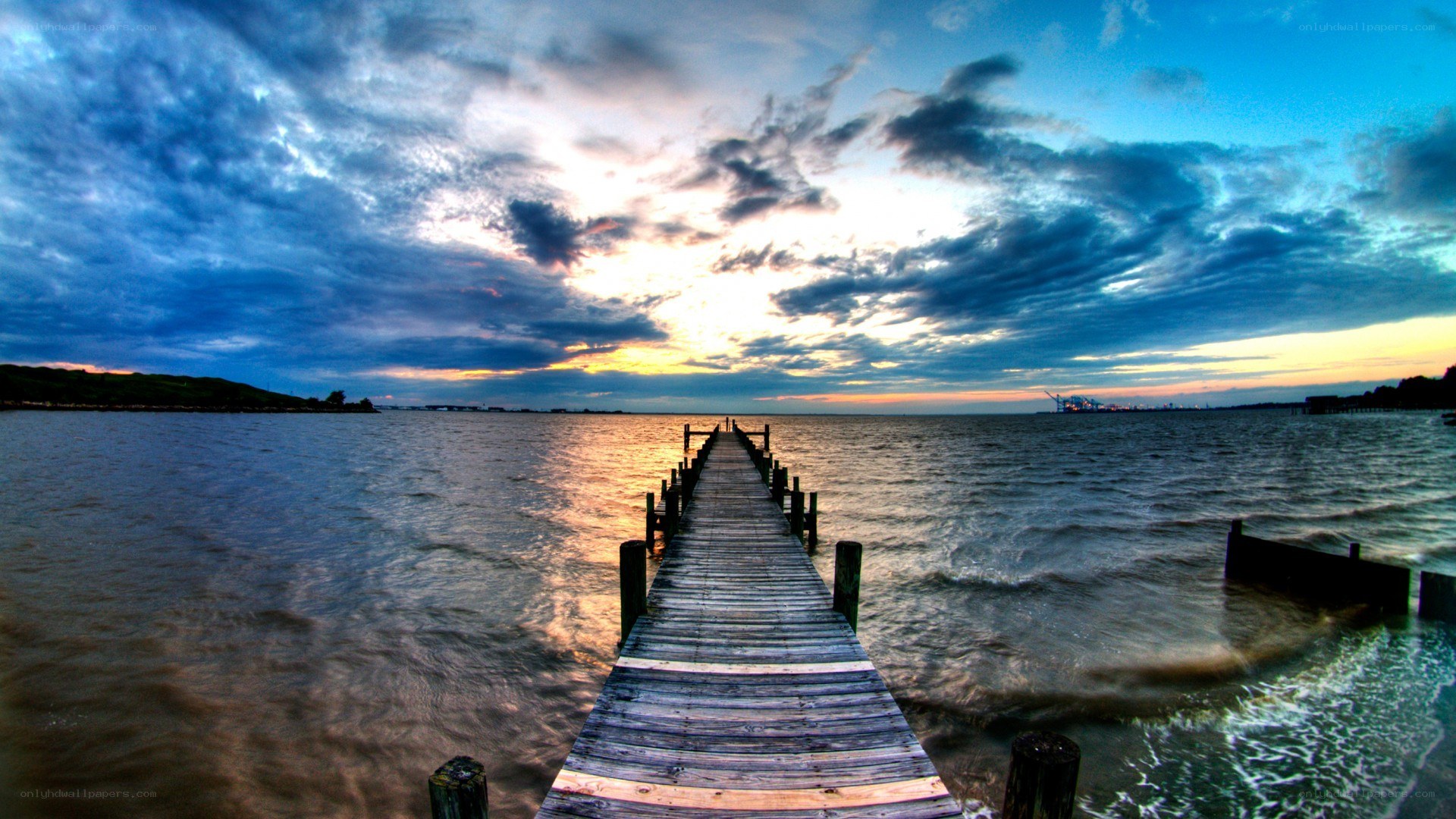 Pier at sunset over water