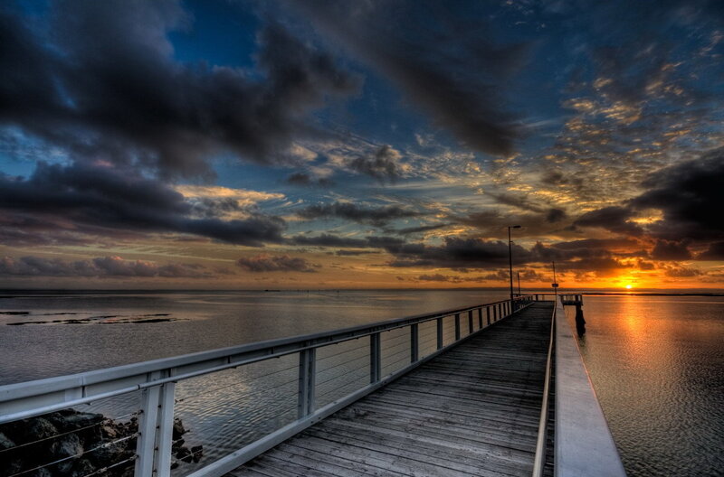 Pier at sunset over water