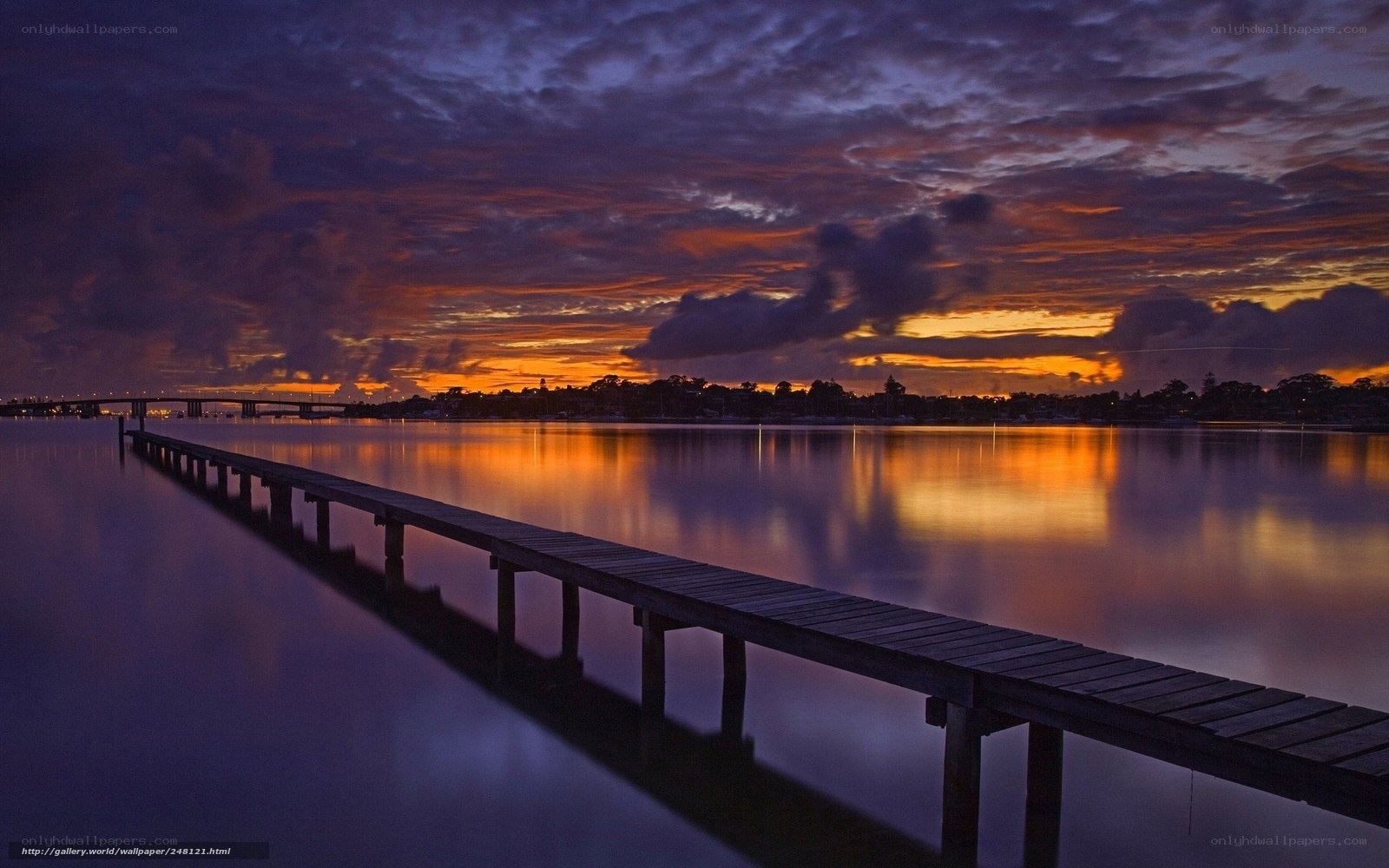 Pier at sunset over water
