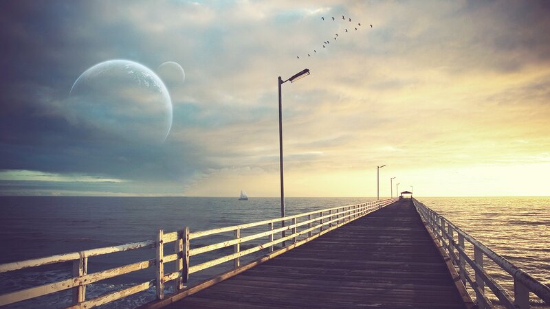 Pier at sunset with alien planets