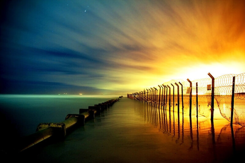 Pier at sunset with barbed wire