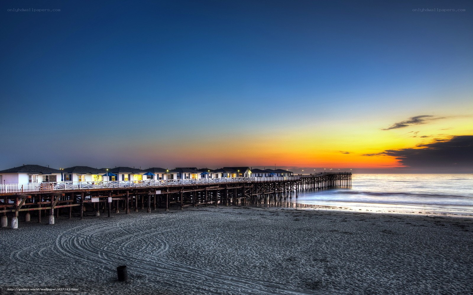 Pier at sunset with beach houses