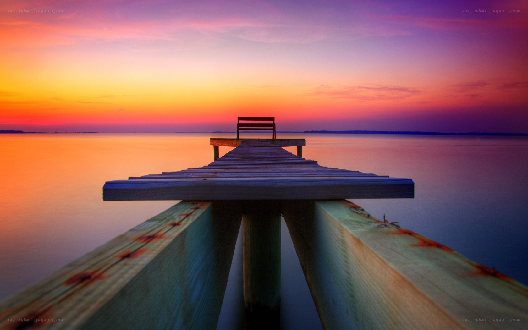 Pier at sunset with bench