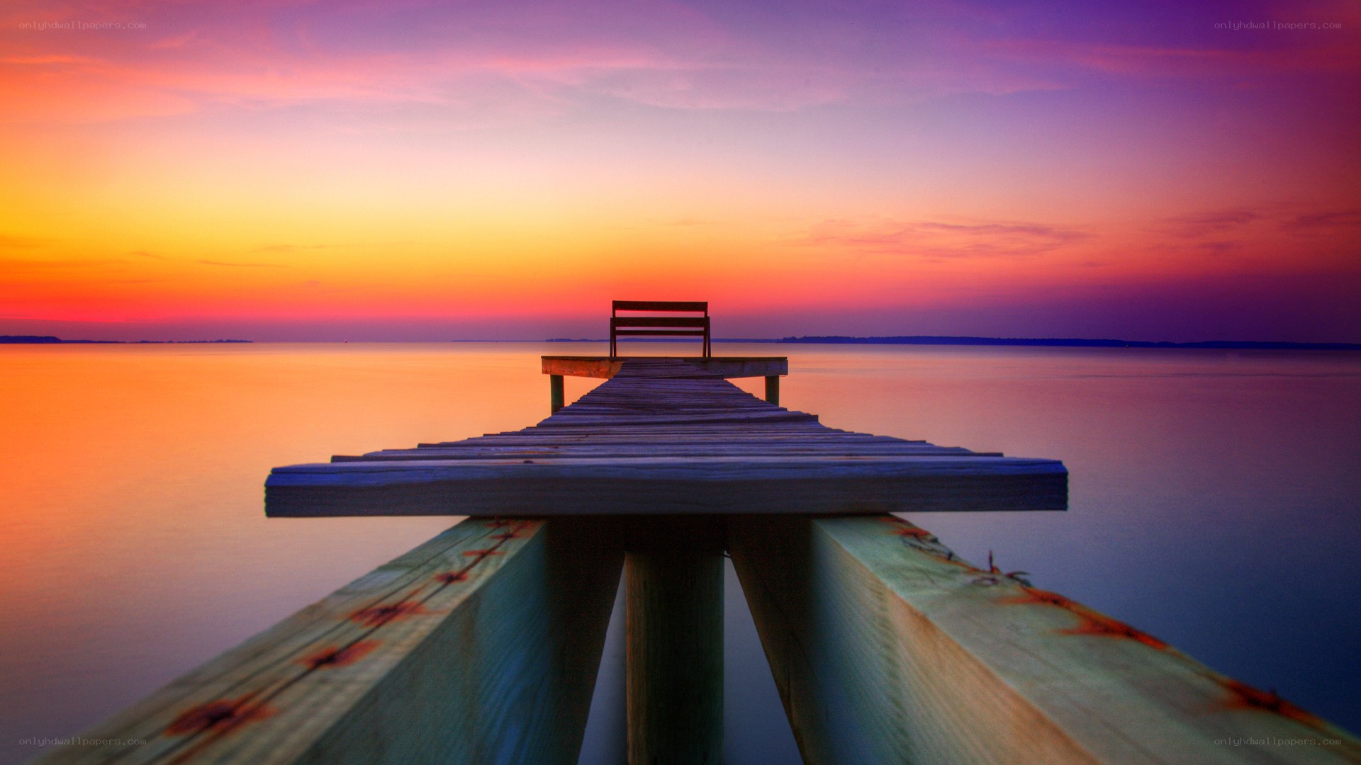 Pier at sunset with bench