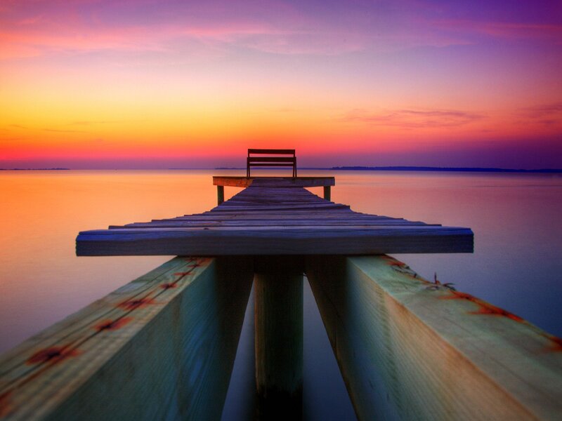 Pier at sunset with bench